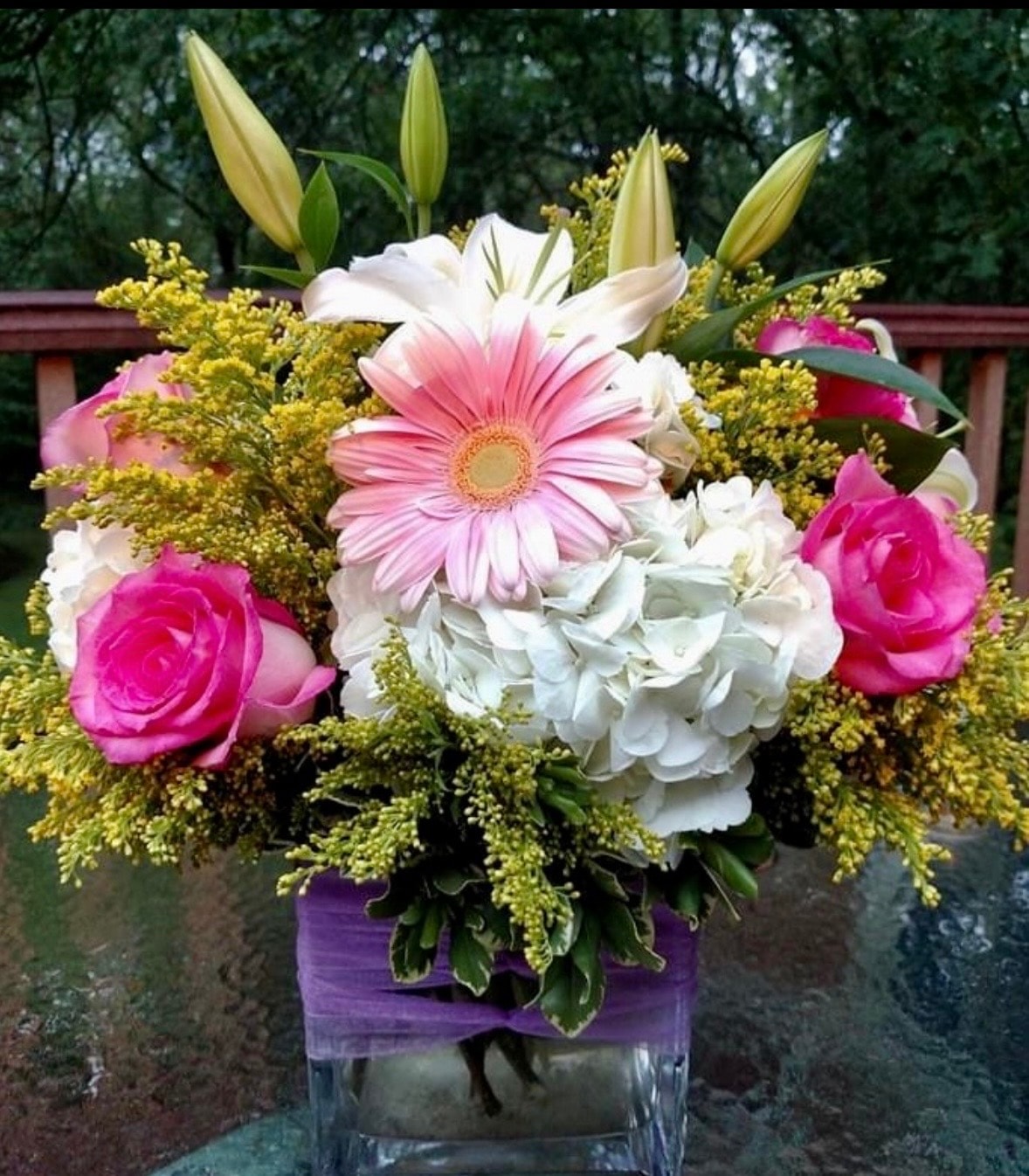 Everyday floral arrangement with stargazer lilies, yellow roses, blue hydrangea and purple stock