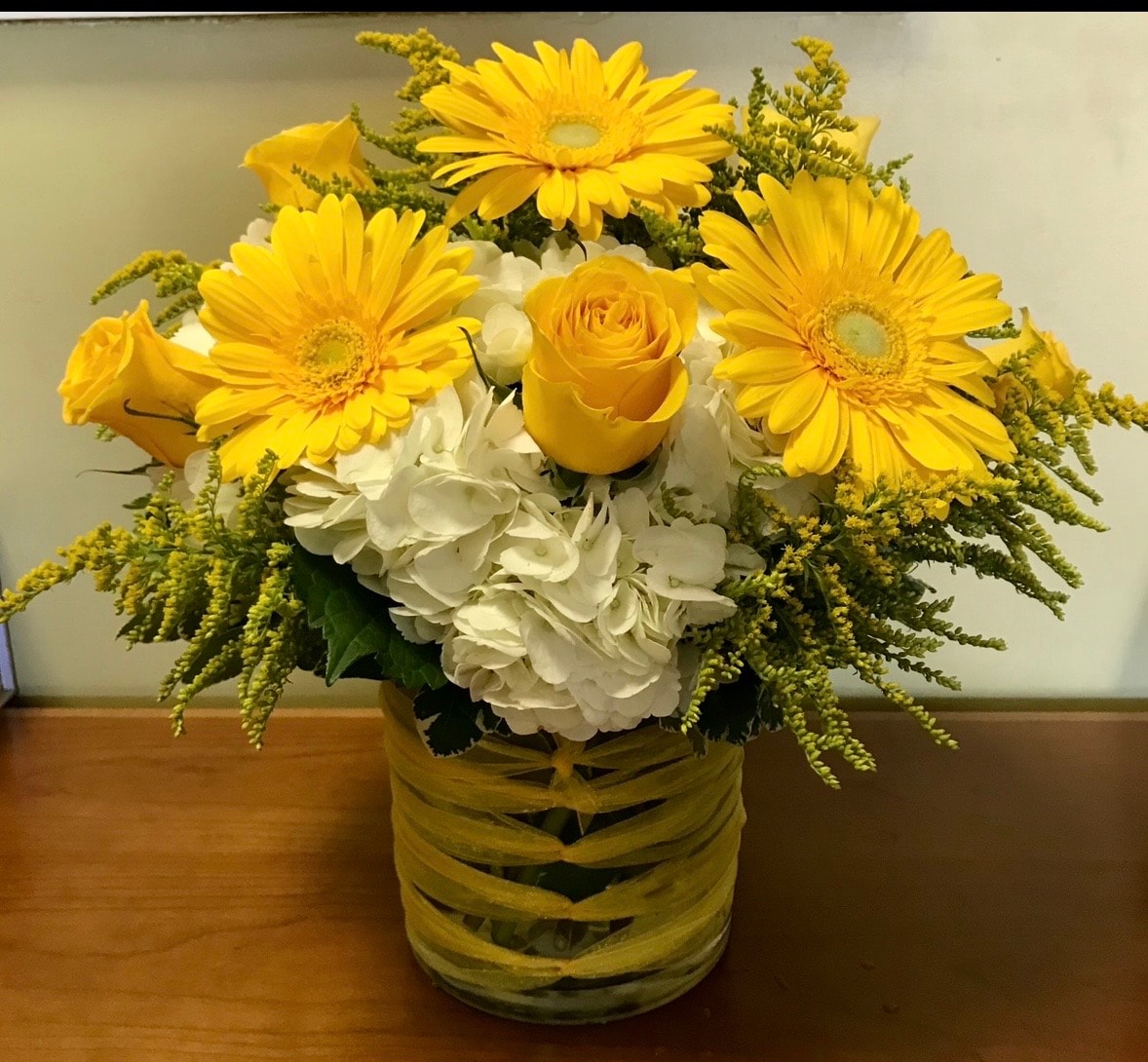 Everyday floral arrangement with pink gerbera daisies, magenta roses and blue hydrangeas